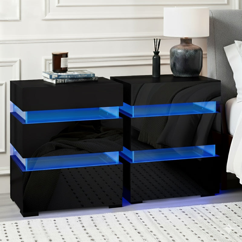 2x Bedside Table LED 3 Drawers - LUMI Black twin pack with blue LED lighting and three drawers in a modern bedroom setting