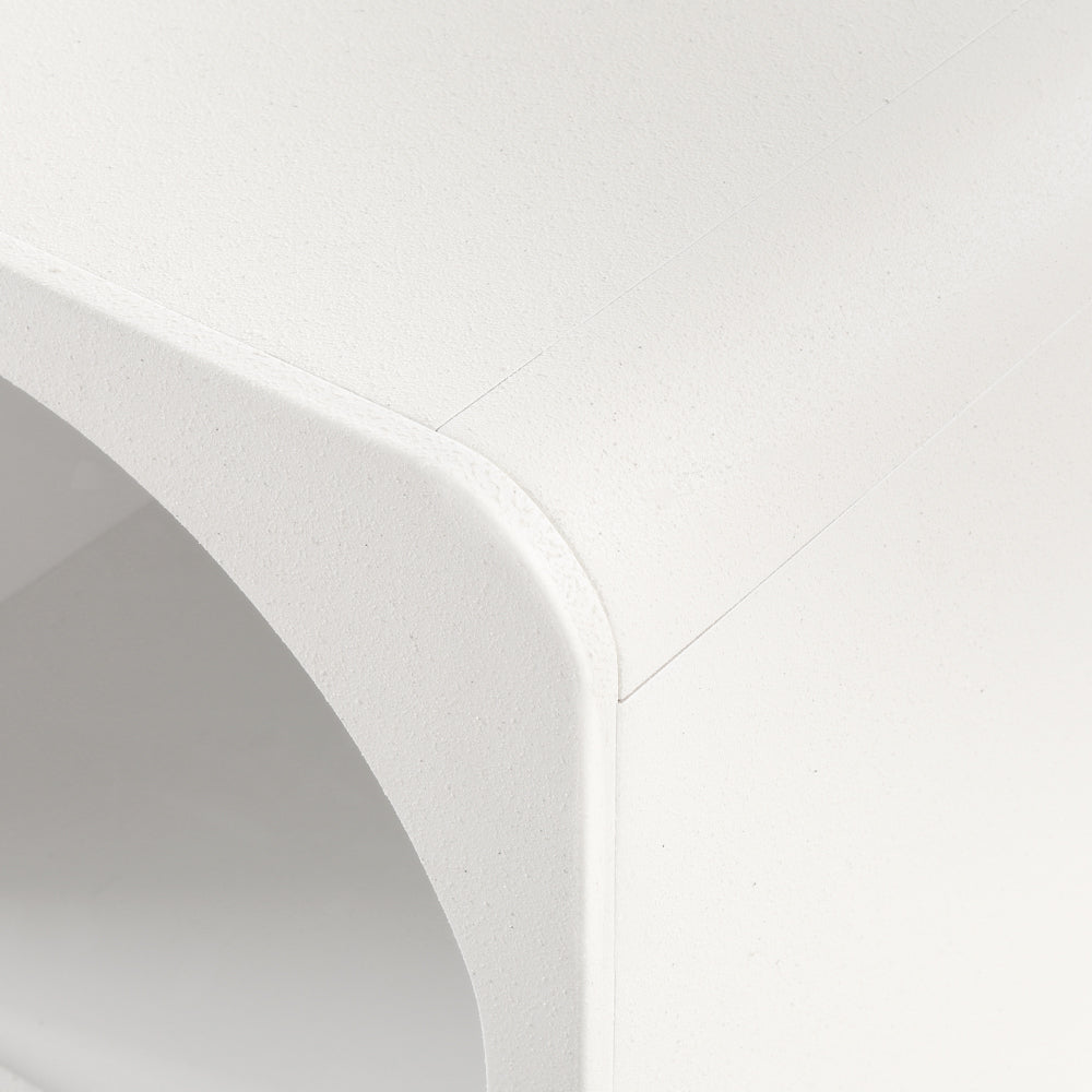 Close-up of the textured surface and curved edge of the Arched Textured Bedside Table White for bedroom furniture.