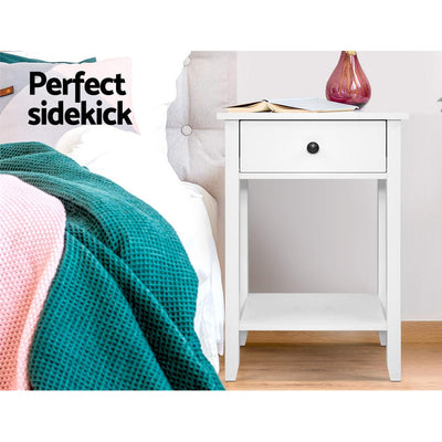 Simple Bedside Table With Drawer White in bedroom setting with drawer, lower shelf, and decorative vase on top