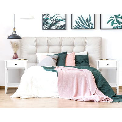 Simple Bedside Table With Drawer White on either side of bed with beige tufted headboard and cozy bedding in bedroom setting