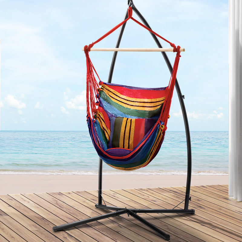 Outdoor Hammock Chair with Steel Stand Hanging Hammock Pillow Rainbow on wooden deck by the ocean under blue sky