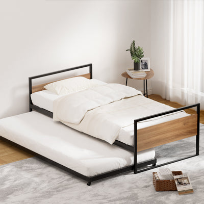 Trundle Single Bed Frame with black metal and wood accents, featuring pull-out lower bed and white bedding in bedroom setting
