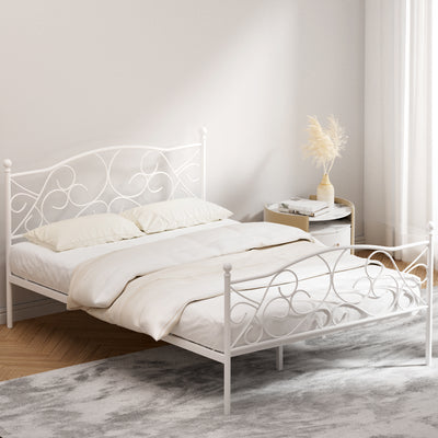 Provincial Style Double Bed Frame White with ornate metal design, white finish, styled in bright bedroom with round side table