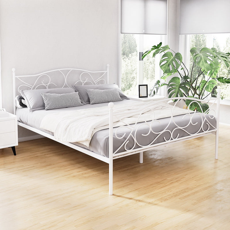 Provincial Style Metal Queen Bed Frame - White with decorative scrollwork, bedding, and bedside table in bright bedroom setting