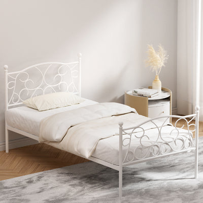 Provincial Style Single Bed Frame White with ornate metal design, dressed in white bedding in a minimalist bedroom setting