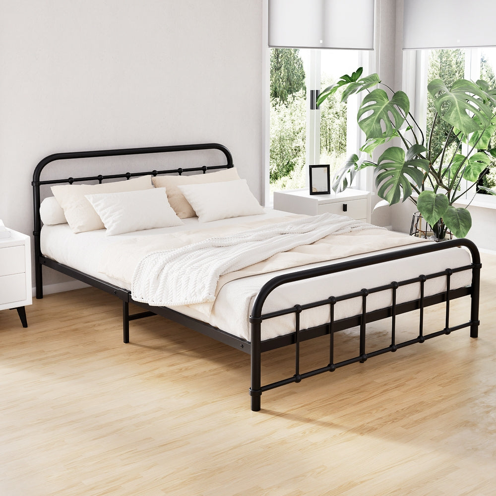 Leo Metal Double Bed Frame Black with sturdy steel construction in a minimalist bedroom setting with white bedding and green plants