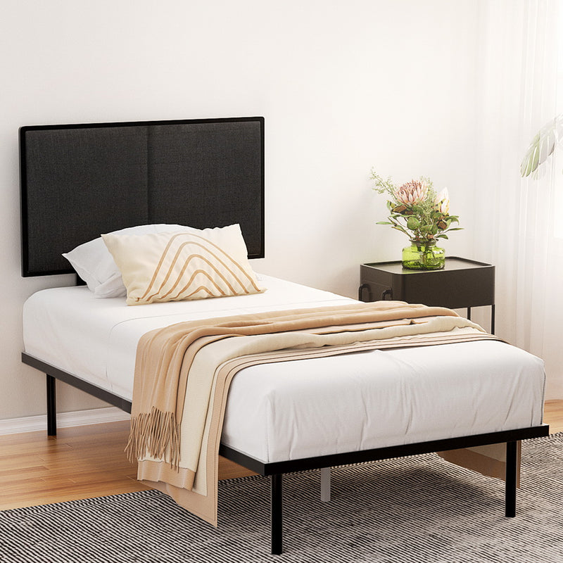 Kembla Metal King Single Bed Frame Black with black upholstered headboard, white bedding, beige throw, and bedside table with flowers
