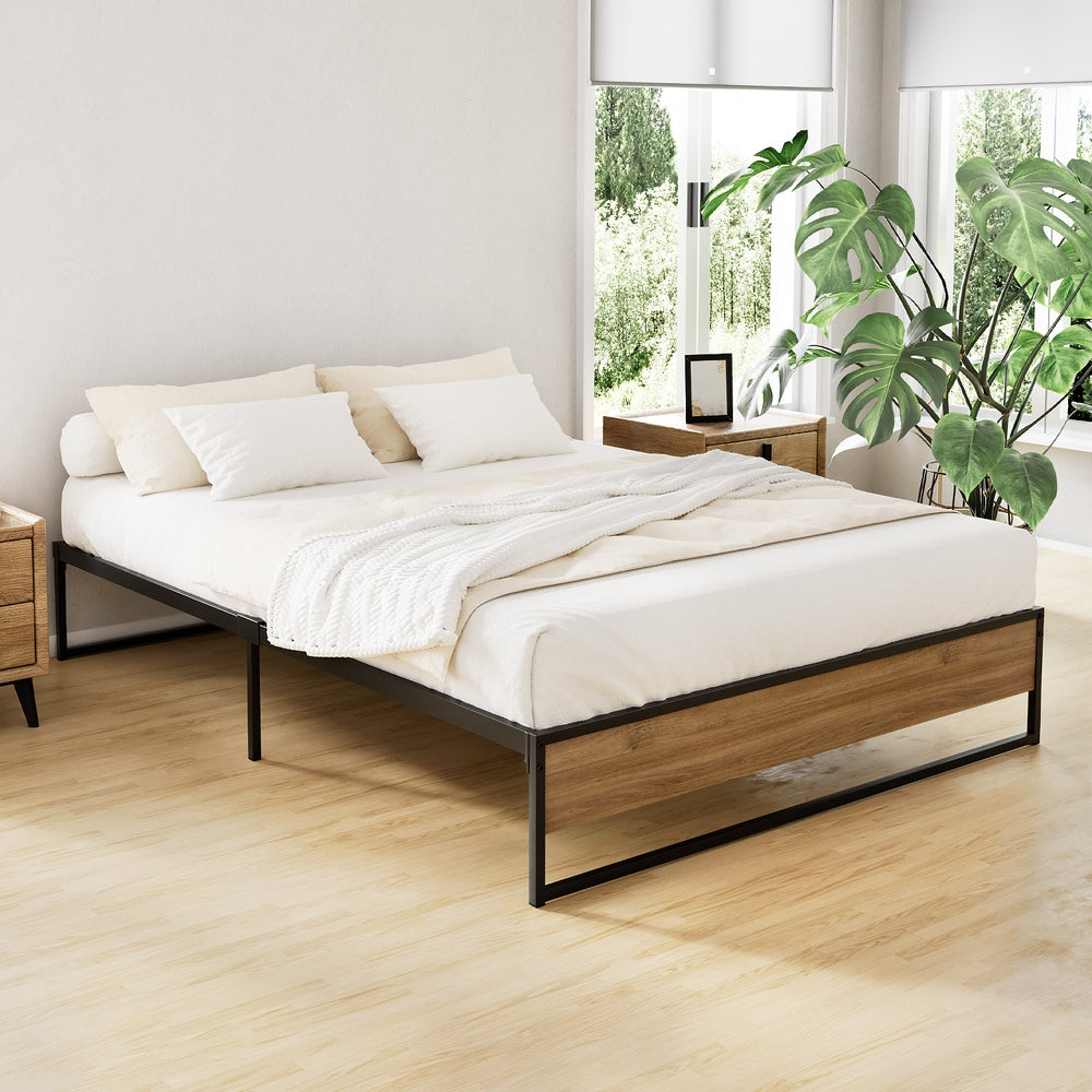 Oslo Metal & Wood Double Bed Frame in black metal and wood finish, styled with neutral bedding in a bright bedroom setting