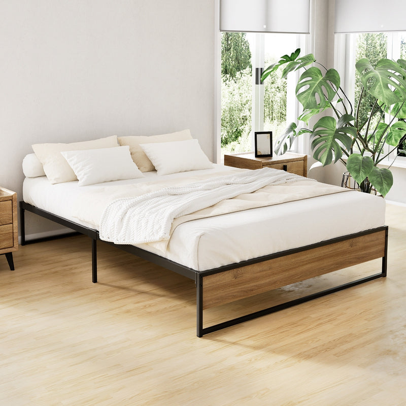 Oslo Metal & Wood Double Bed Frame in black metal and wood finish, styled with neutral bedding in a bright bedroom setting