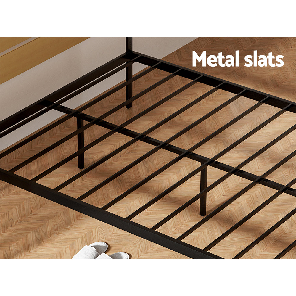 Paula Double Metal Bed Frame Black With Wooden Headboard showing black metal slats on wooden floor in bedroom setting