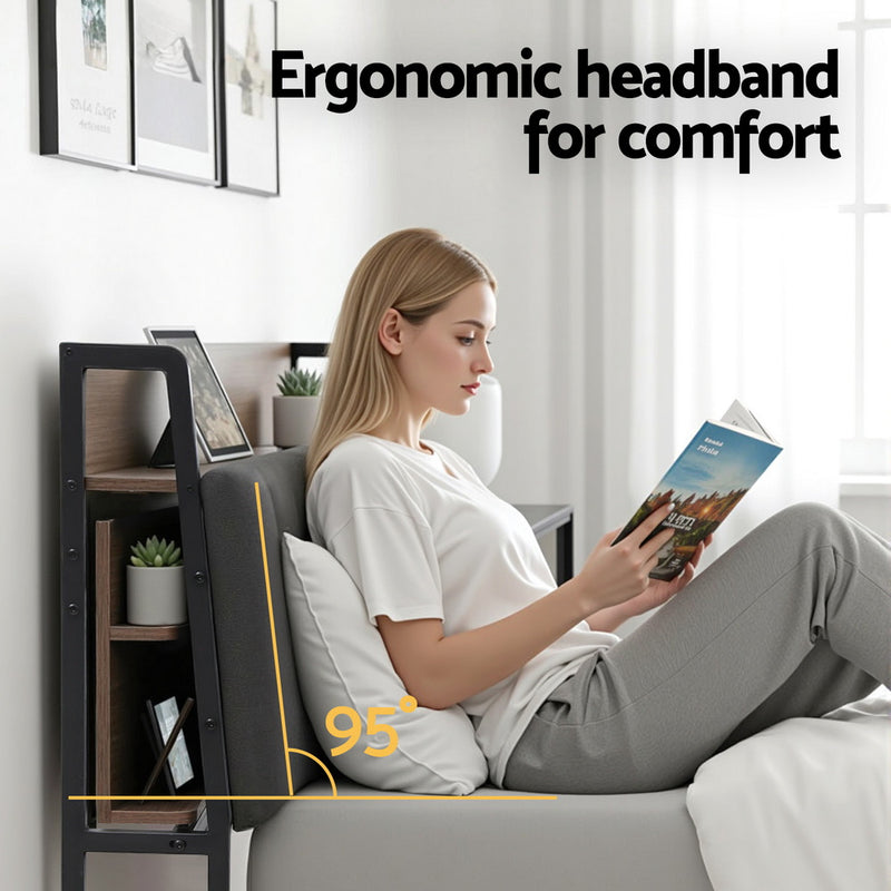 Woman sitting on Sotera Double Upholstered Storage Bed Frame with Charging Station – Oak/Grey reading, highlighting ergonomic headband design