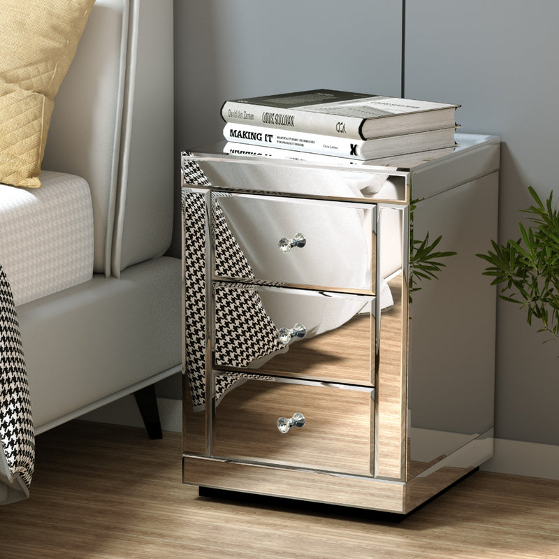 Mirrored Bedside Table Drawers Furniture Mirror Glass Presia Silver with three drawers next to upholstered bed in bedroom setting
