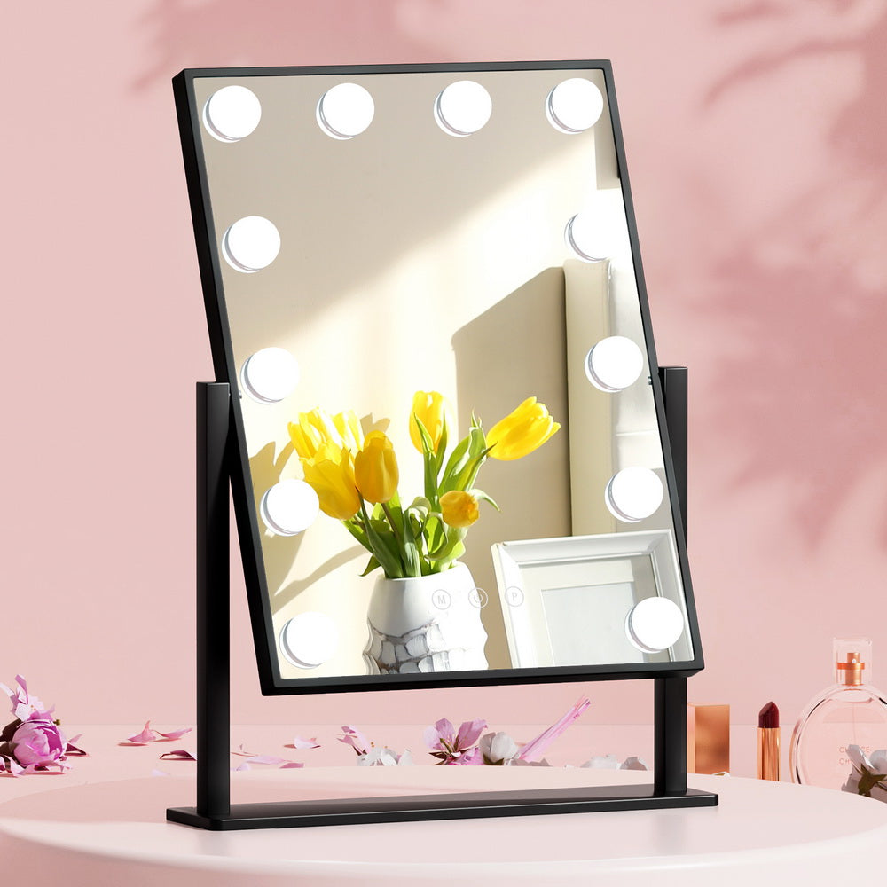 Makeup Mirror 30x48cm Hollywood Vanity with LED Light Rotation Tabletop on pink surface with flowers and perfume bottles