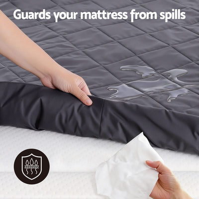 Water-Resistant Mattress Protector Microfiber 360° Fit King showing spill protection on quilted black surface with hands and wipe