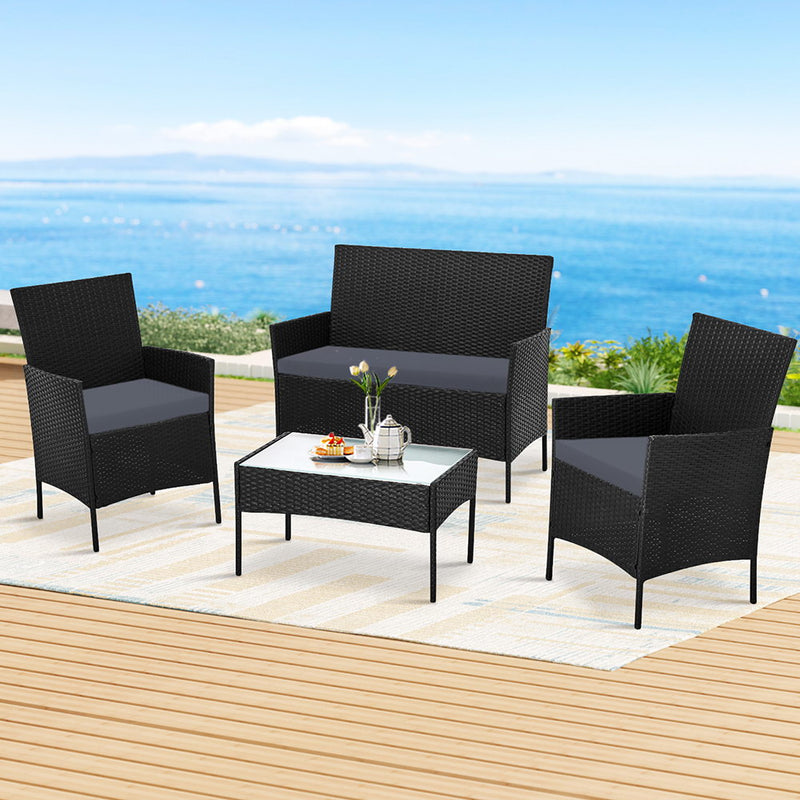 4 Seater Outdoor Sofa Set Wicker Setting Table Chair Furniture Dark Grey with cushions on patio by the sea