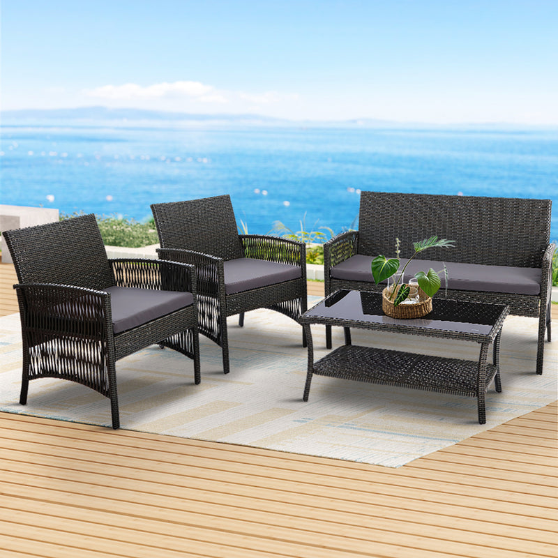 4PCS Outdoor Sofa Set Wicker Harp Chair Table Garden Furniture Grey with cushions on patio overlooking ocean background