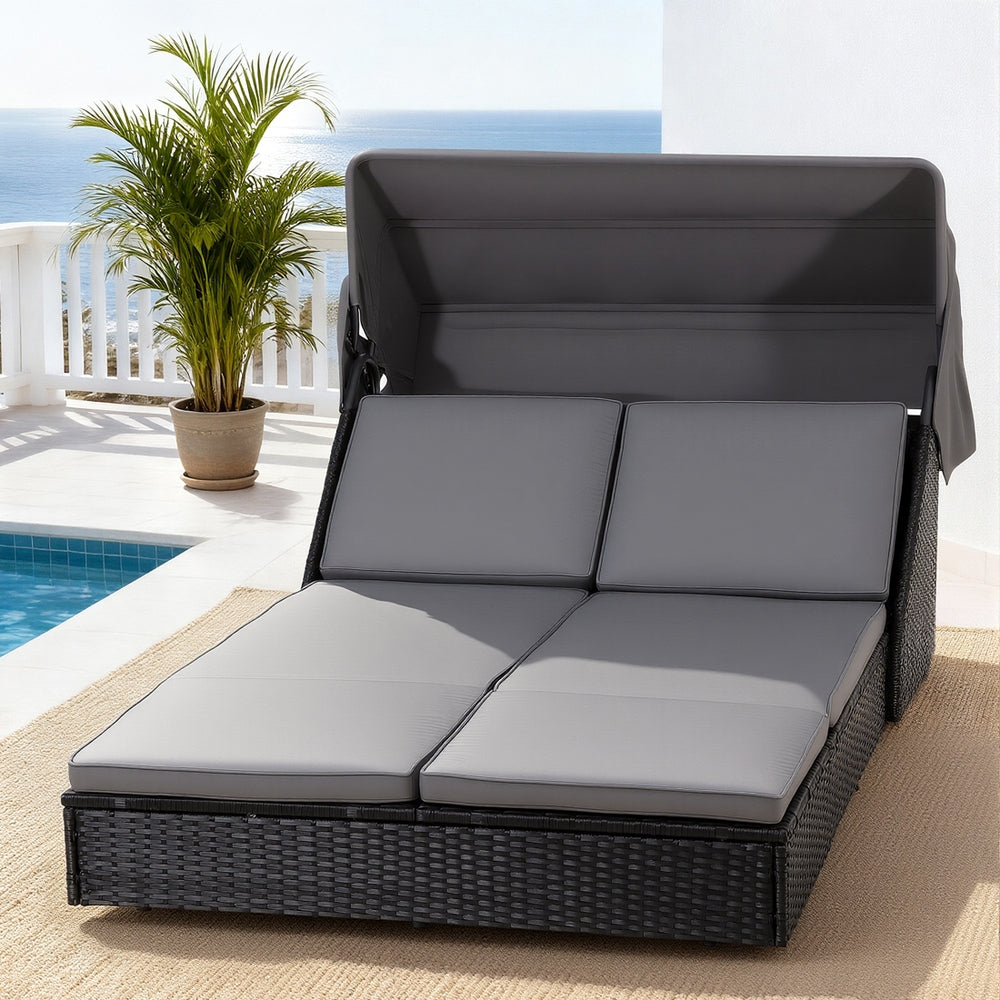 Outdoor Day Bed Sun Lounge Setting Wicker Lounger Patio Furniture with adjustable canopy and gray cushions by the poolside