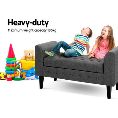 Fabric Storage Ottoman - Grey with tufted upholstery, sturdy legs, shown with children playing and colorful toys nearby