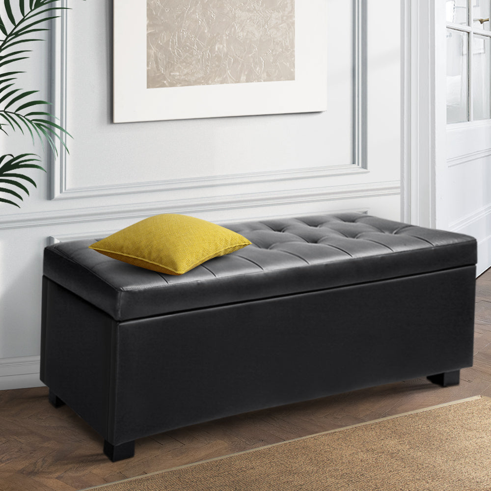 PU Leather Storage Ottoman - Black with tufted top, rectangular design, and yellow cushion in modern bedroom setting.