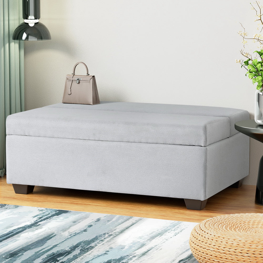 Ottoman Storage Sofa Bed 112cm Foldable Grey with linen upholstery, storage compartment, and dark wooden legs in modern room setting
