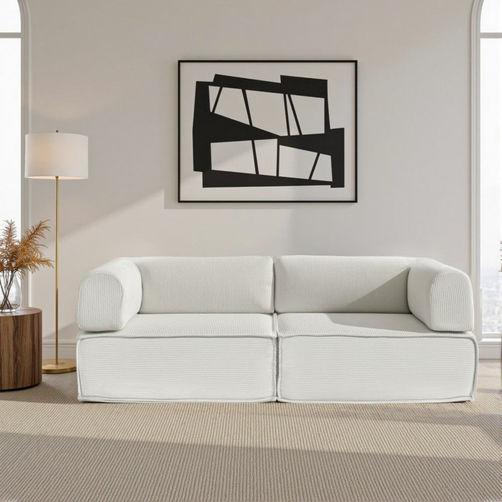 Convertible Folding Sofa Bed Beign in beige fabric with clean lines, set in modern living room with abstract wall art and lamp
