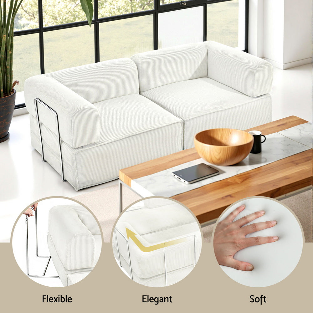 Convertible Folding Sofa Bed Beign in white fabric with steel frame, shown as sofa with wood coffee table and natural light.
