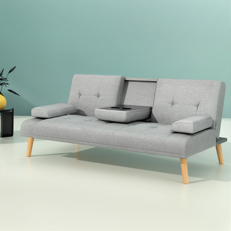 3 Seater Fabric Sofa Bed (Grey) with tufted cushions, wooden legs, and a center console with cup holders on light background