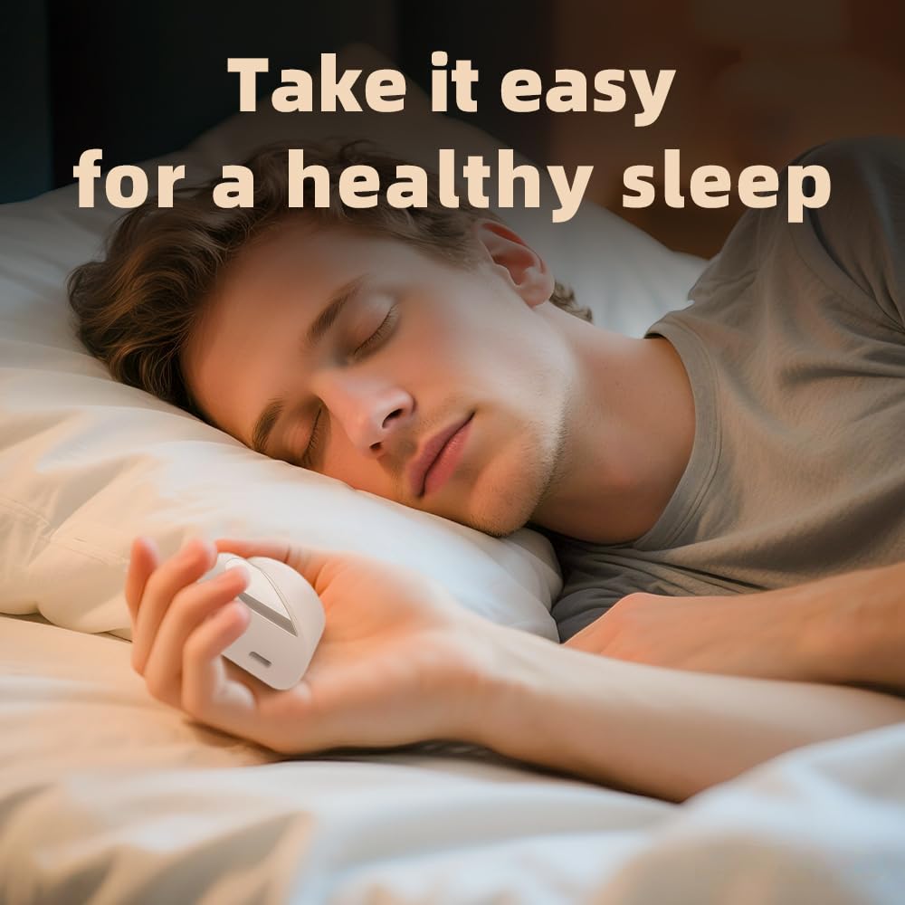 Young man sleeping on bed holding White Handheld Sleep Aid Device: Smart Relaxation Tool with Dual Modes & LED Display