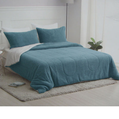 Nolan Steel Blue 4 Piece Comforter Set Queen on bed with matching pillows in modern bedroom setting by Bedzy