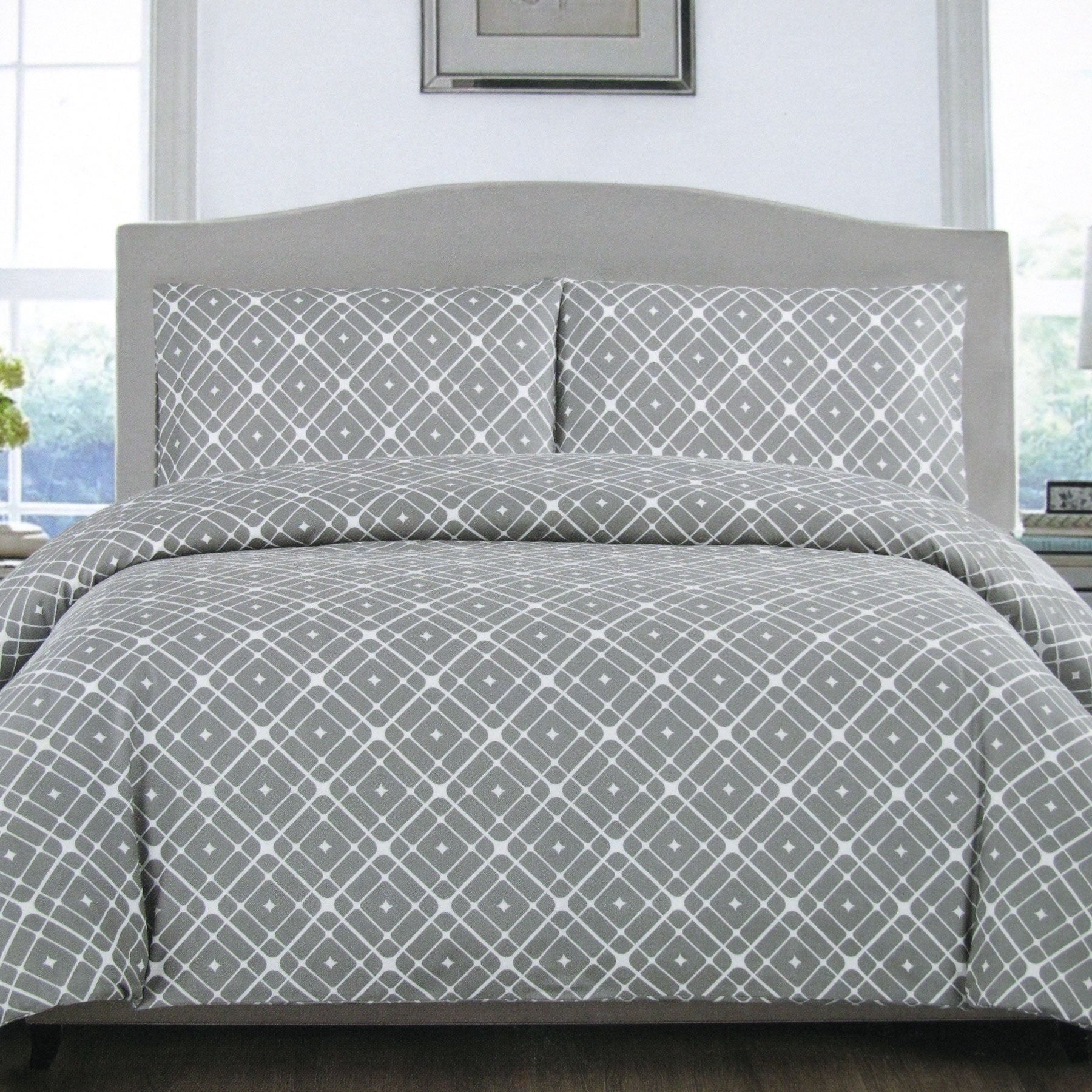 Artex Grey Stars Quilt Cover Set Queen on bed, featuring geometric grey and white star pattern in bedroom setting