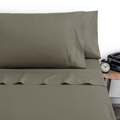 Artex 250TC Polyester Cotton Sheet Set Single Walnut displayed on bed with wooden side table, clock, and books