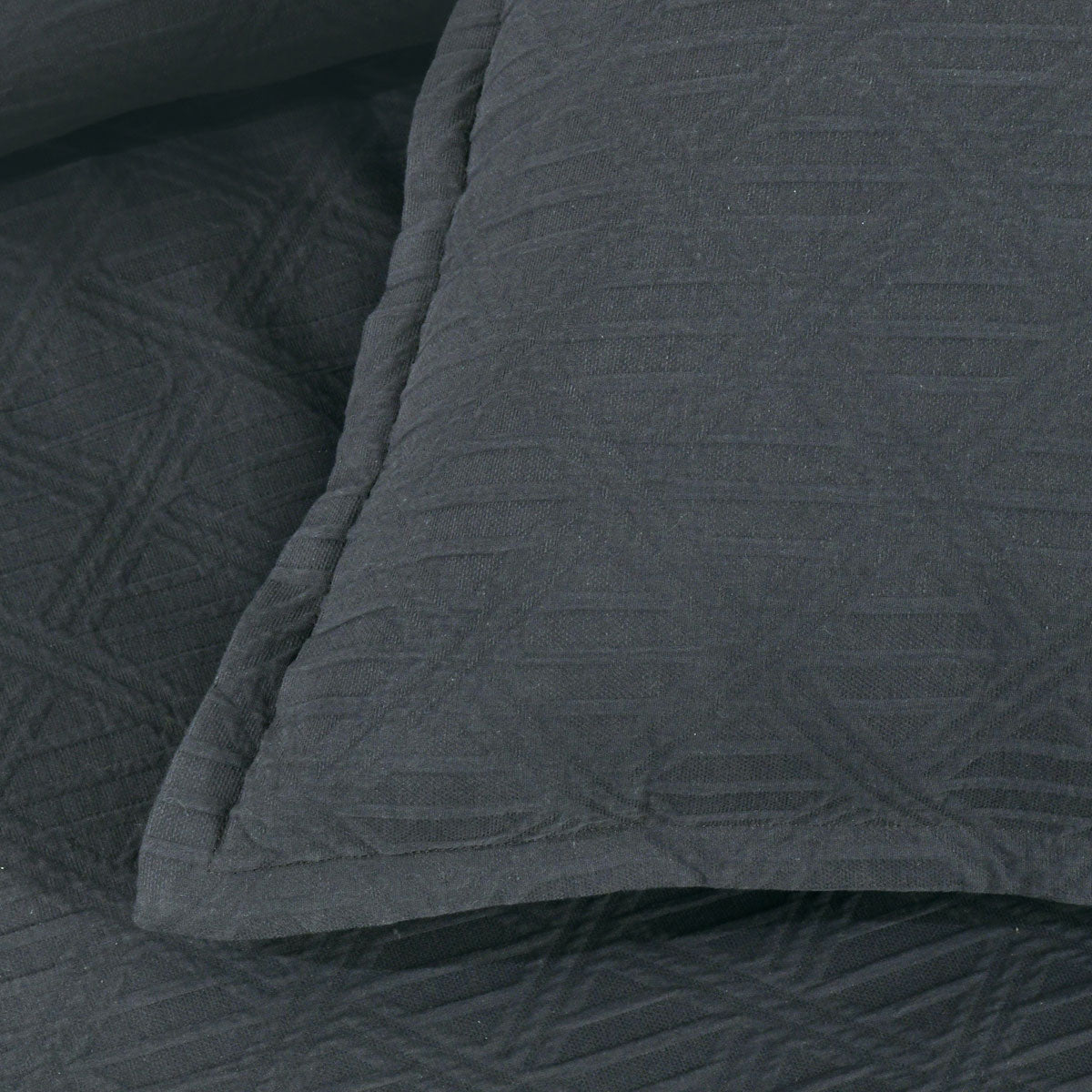 Close-up of Bianca Hallston Charcoal Pre-Washed Cotton Quilt Cover Set Super King showing diamond jacquard pattern and tailored edge