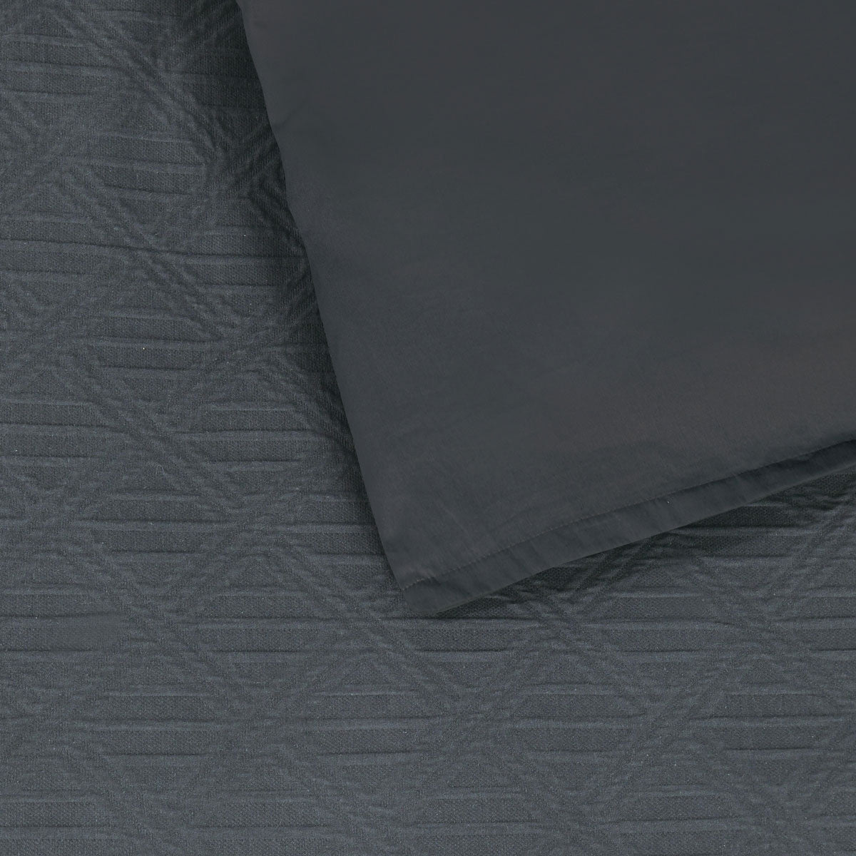 Close-up of Bianca Hallston Charcoal Pre-Washed Cotton Quilt Cover Set Super King with diamond jacquard pattern and tailored edges