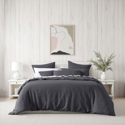 Bianca Kahlani Charcoal Waffle Quilt Cover Set Double on bed with white bedside tables and modern wall art in bedroom setting