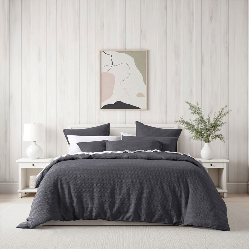Bianca Kahlani Charcoal Waffle Quilt Cover Set Double on bed with white bedside tables and modern wall art in bedroom setting