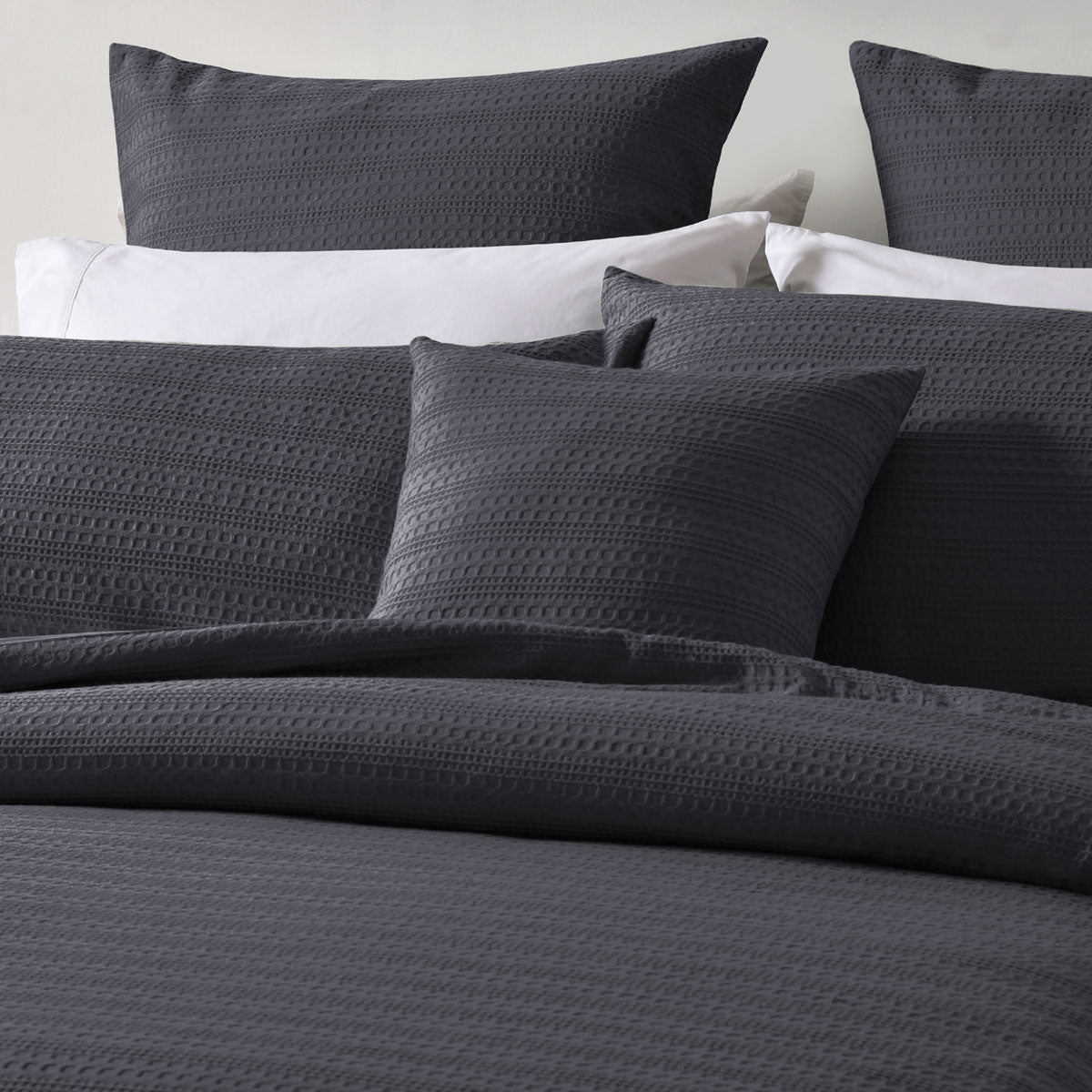 Bianca Kahlani Charcoal Waffle Quilt Cover Set Double with textured charcoal waffle fabric and matching pillowcases on bed