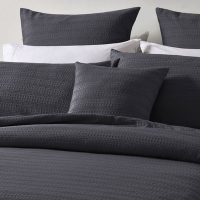 Bianca Kahlani Charcoal Waffle Quilt Cover Set Double with textured charcoal waffle fabric and matching pillowcases on bed