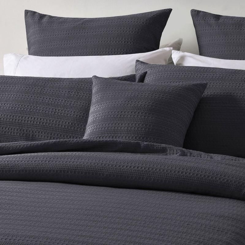 Bianca Kahlani Charcoal Waffle Quilt Cover Set Double with textured charcoal waffle fabric and matching pillowcases on bed