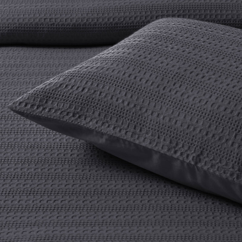 Bianca Kahlani Charcoal Waffle Quilt Cover Set Queen in textured charcoal waffle fabric with matching pillowcase on a bed