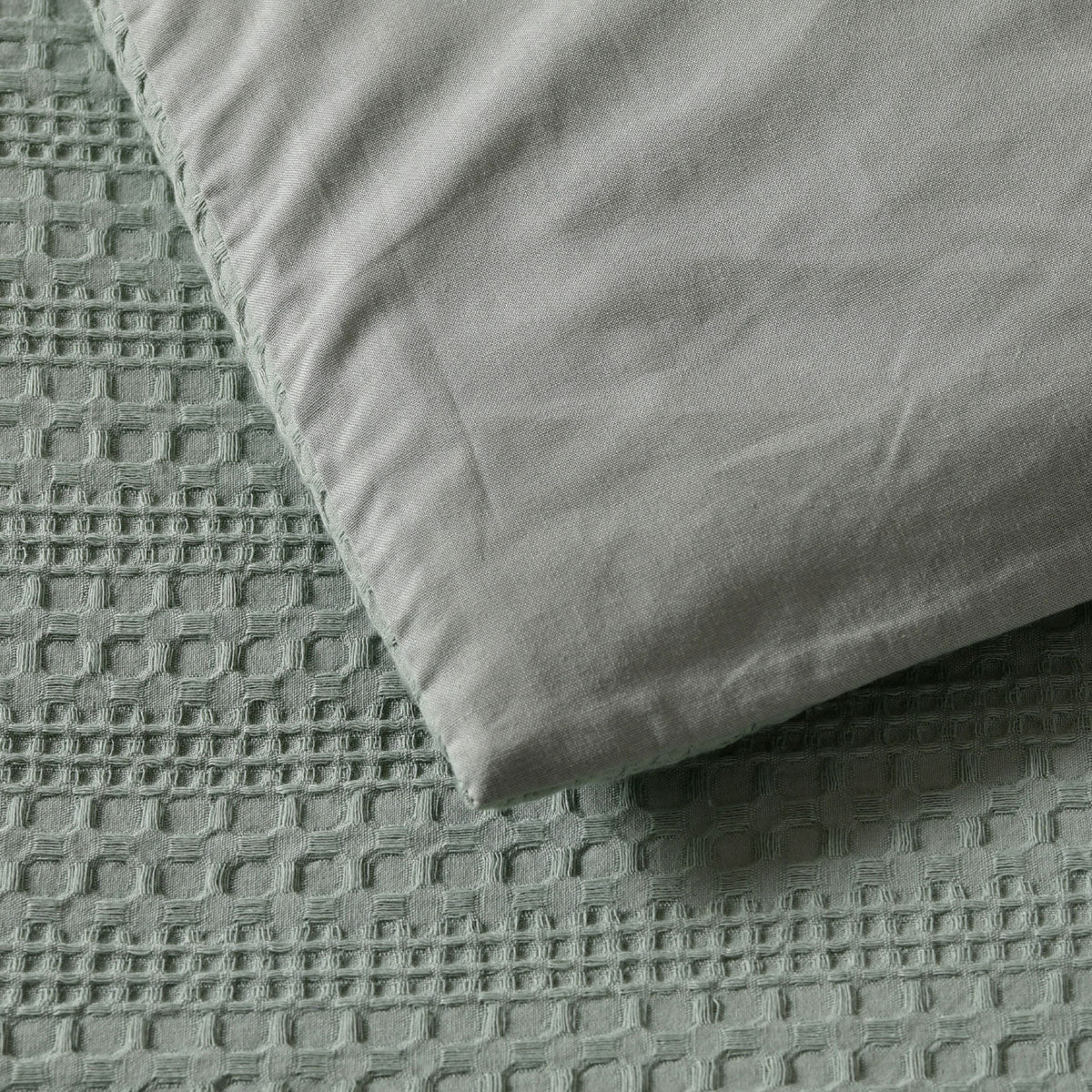Close-up of Bianca Kahlani Sage Waffle Quilt Cover Set Double showing textured waffle jacquard fabric in sage color