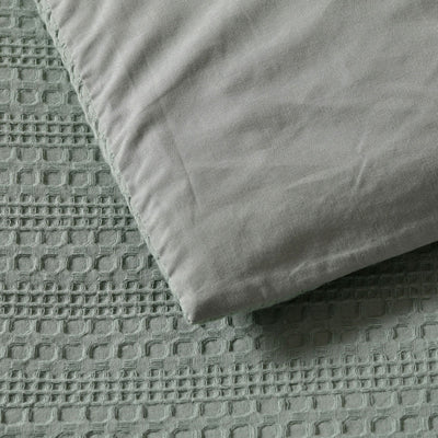 Close-up of Bianca Kahlani Sage Waffle Quilt Cover Set Double showing textured waffle jacquard fabric in sage color