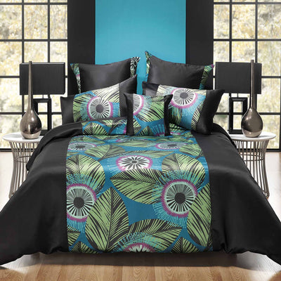 Black Quilt Cover Set Queen with vibrant jungle print, featuring green, pink, and blue tones with black piped border on bed.