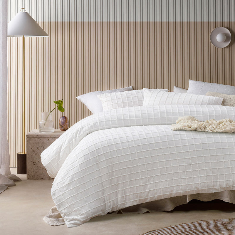 Vintage Design Homewares Parquet White Cotton Quilt Cover Set King on bed in neutral bedroom with textured wall paneling and bedside lamp
