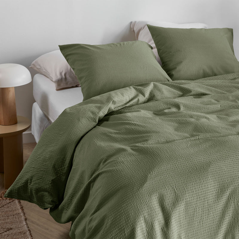 Bedding House Summer Green Seersucker Cotton Quilt Cover Set King on bed with matching pillowcases in a modern bedroom setting