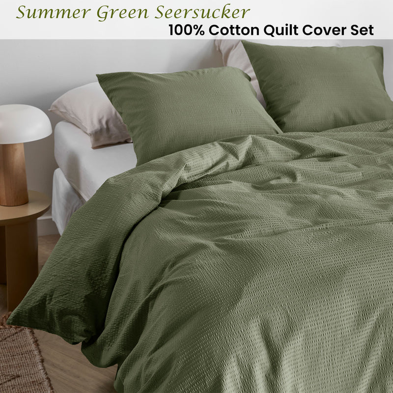 Bedding House Summer Green Seersucker Cotton Quilt Cover Set King on bed with neutral pillows and wooden side table