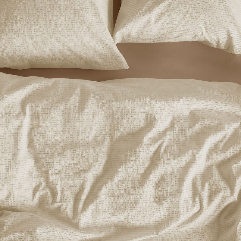 Bedding House Summer Sand Seersucker Cotton Quilt Cover Set King in sand color on a bed with matching pillowcases