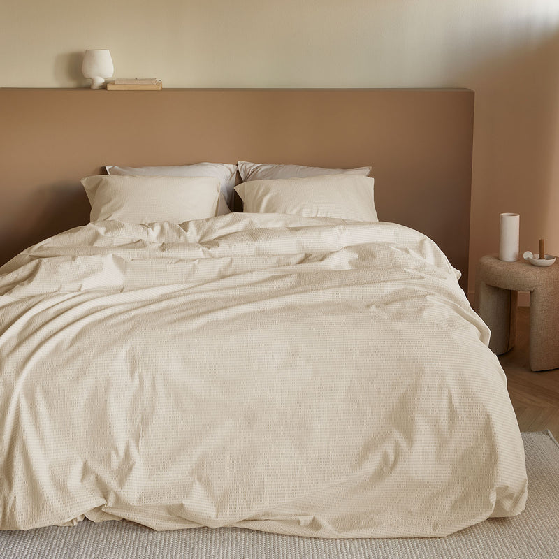 Bedding House Summer Sand Seersucker Cotton Quilt Cover Set Queen on a made bed with matching pillowcases in a neutral bedroom setting
