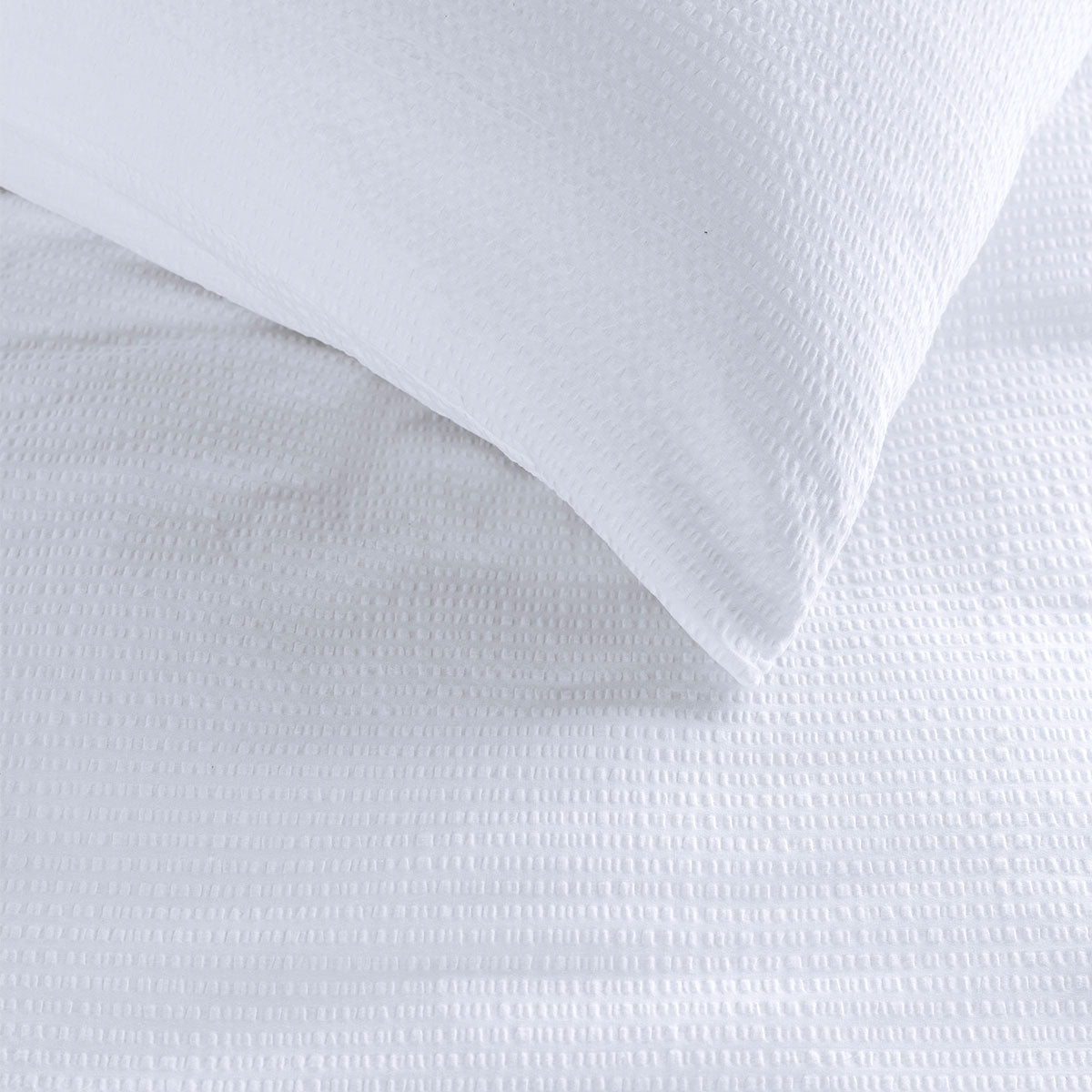 Bedding House Summer White Seersucker Cotton Quilt Cover Set King on a bed with textured cotton fabric detail