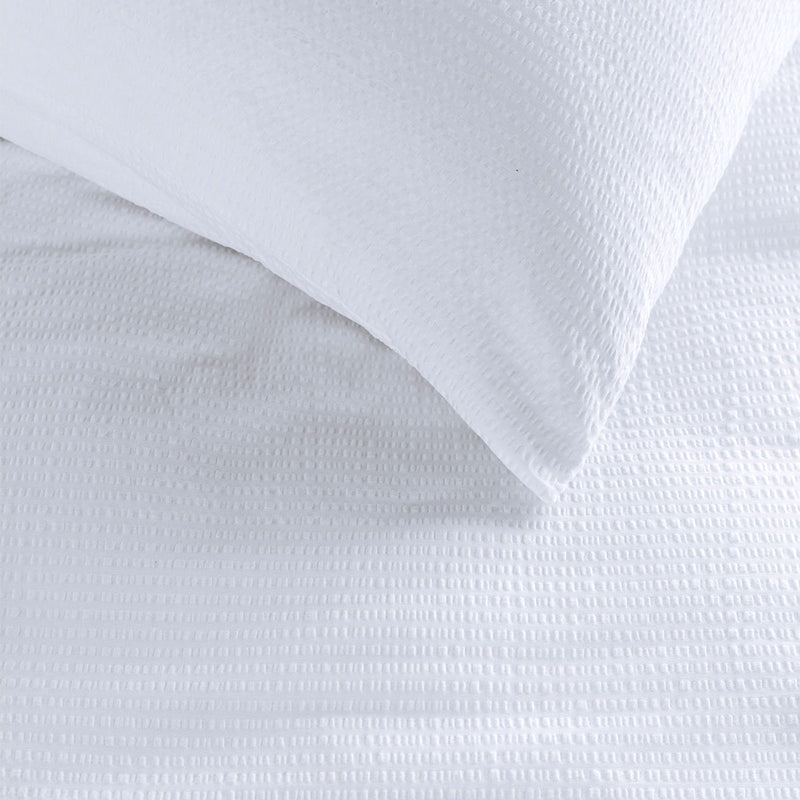 Bedding House Summer White Seersucker Cotton Quilt Cover Set King on a bed with textured cotton fabric detail