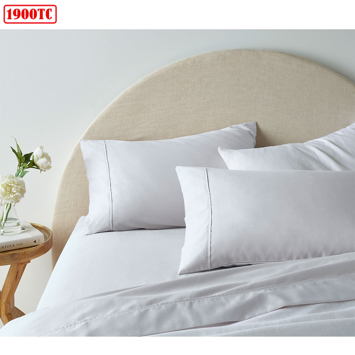 1900TC Cotton Rich Sheet Set White King neatly arranged on a bed with beige curved headboard and wooden side table